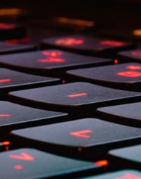 Overlooking view of a black keyboard with red highlights for the characters.